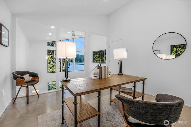 13703 Tastad Rd, Arlington, WA 98223 - home office with finished concrete flooring, baseboards, a ceiling fan, recessed lighting, and high vaulted ceiling