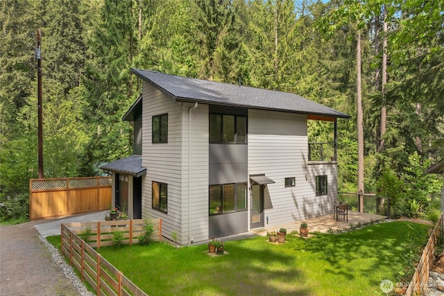 13703 Tastad Rd, Arlington, WA 98223 - view of front of home featuring a shingled roof, a patio, a forest view, and asphalt driveway
