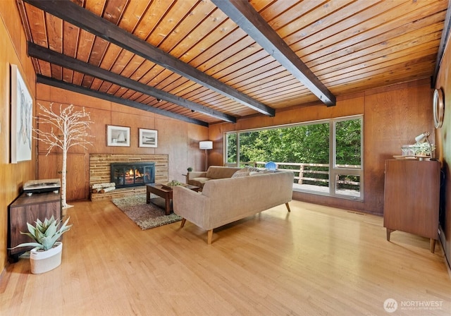 6217 Hillcrest Dr SW, Lakewood, WA 98499 - living room with wood walls, wood finished floors, a glass covered fireplace, and wood ceiling