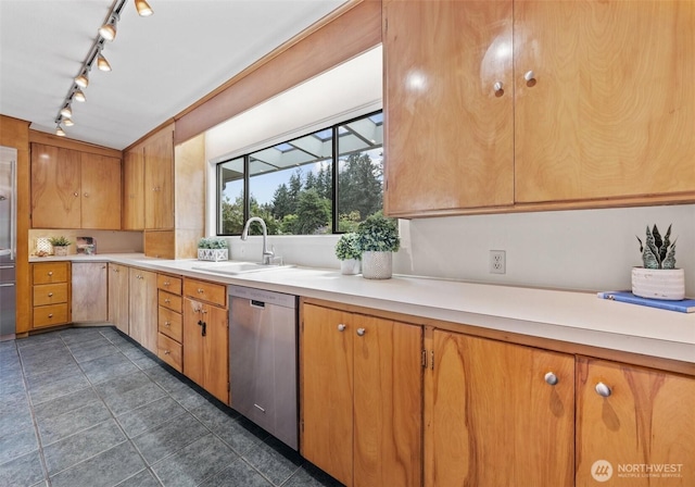 6217 Hillcrest Dr SW, Lakewood, WA 98499 - kitchen featuring stainless steel dishwasher, a sink, track lighting, light countertops, and dark tile patterned floors