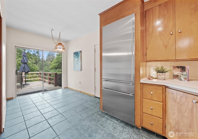 6217 Hillcrest Dr SW, Lakewood, WA 98499 - kitchen with stainless steel built in fridge, baseboards, tile patterned flooring, light countertops, and decorative light fixtures