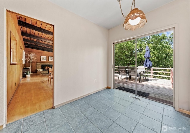 6217 Hillcrest Dr SW, Lakewood, WA 98499 - empty room featuring baseboards, wood walls, and tile patterned floors