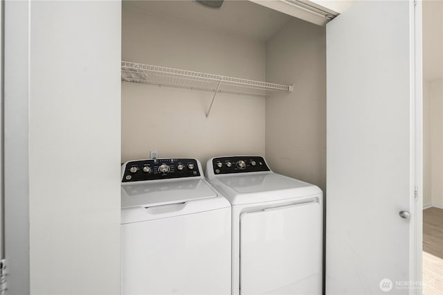 1133 63rd St SE Unit A, Auburn, WA 98092 - laundry area featuring washer and dryer, wood finished floors, and baseboards