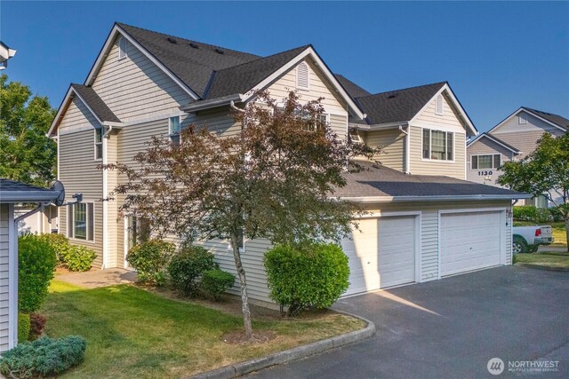 1133 63rd St SE Unit A, Auburn, WA 98092 - view of front of home with asphalt driveway, an attached garage, a shingled roof, and a front lawn