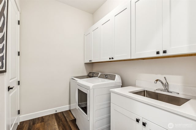 10610 134th Dr NE Unit 111, Lake Stevens, WA 98258 - washroom featuring cabinet space, washing machine and dryer, dark wood-style flooring, and baseboards