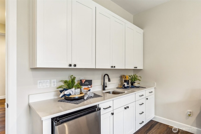 10610 134th Dr NE Unit 111, Lake Stevens, WA 98258 - kitchen featuring a sink, baseboards, dark wood-style floors, light countertops, and white cabinets