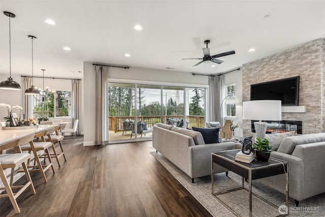 10610 134th Dr NE Unit 111, Lake Stevens, WA 98258 - living room featuring dark wood finished floors, a ceiling fan, recessed lighting, a stone fireplace, and baseboards
