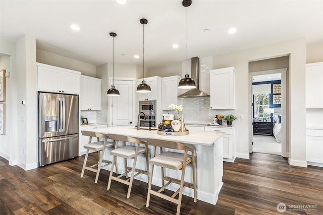 10610 134th Dr NE Unit 111, Lake Stevens, WA 98258 - kitchen featuring stainless steel appliances, wall chimney exhaust hood, light countertops, tasteful backsplash, and white cabinets