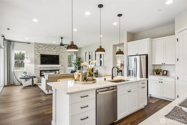 10610 134th Dr NE Unit 111, Lake Stevens, WA 98258 - kitchen with stainless steel appliances, a sink, plenty of natural light, dark wood finished floors, and recessed lighting