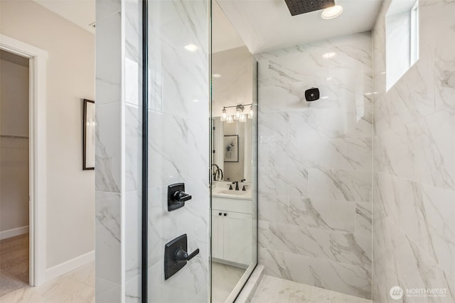 10610 134th Dr NE Unit 111, Lake Stevens, WA 98258 - full bathroom featuring a marble finish shower, vanity, marble look tile flooring, a walk in closet, and baseboards