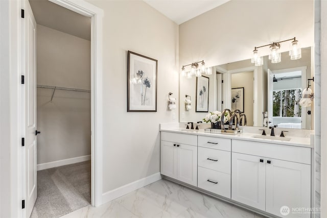 10610 134th Dr NE Unit 111, Lake Stevens, WA 98258 - bathroom with double vanity, baseboards, marble look tile flooring, and a spacious closet