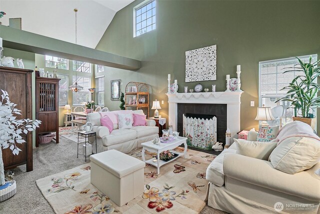 7608 145th Avenue Ct E, Sumner, WA 98390 - living area featuring high vaulted ceiling, a tiled fireplace, and carpet floors