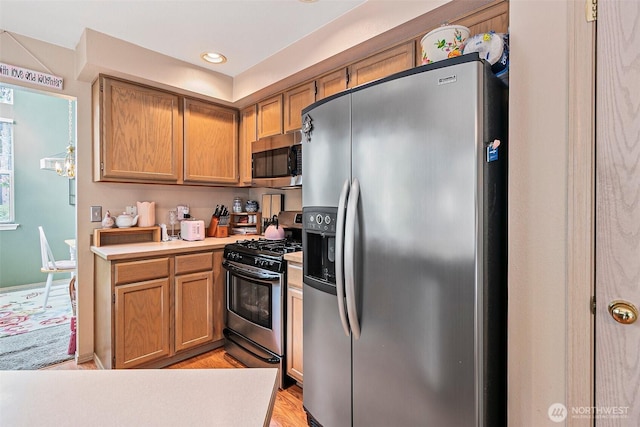 7608 145th Avenue Ct E, Sumner, WA 98390 - kitchen featuring stainless steel appliances, light countertops, a chandelier, recessed lighting, and light wood-type flooring
