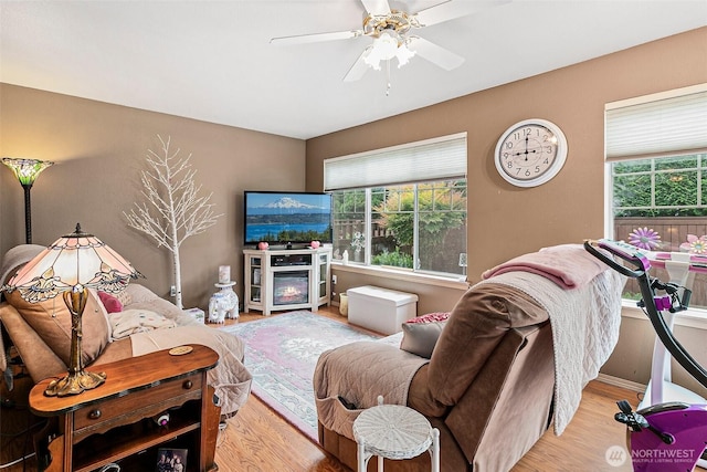 7608 145th Avenue Ct E, Sumner, WA 98390 - living room with healthy amount of natural light, light wood-type flooring, and a ceiling fan