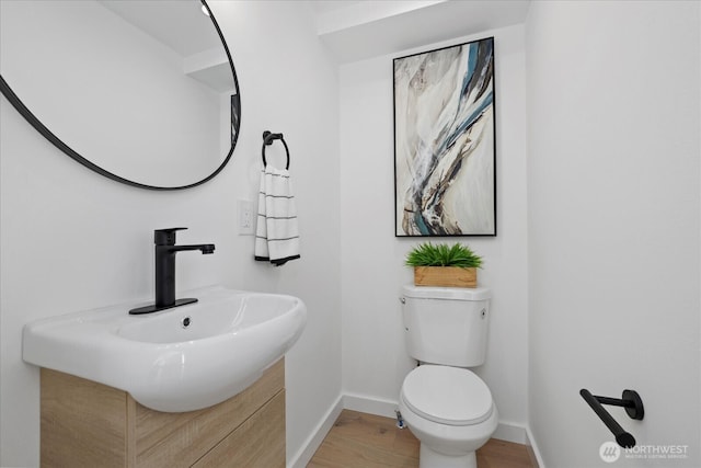 6032 42nd Ave SW Unit C, Seattle, WA 98136 - half bathroom with baseboards, wood finished floors, toilet, and vanity