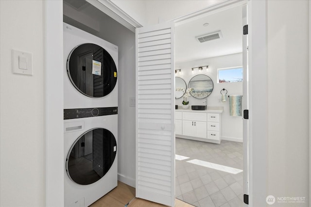 6032 42nd Ave SW Unit C, Seattle, WA 98136 - laundry area with stacked washer / drying machine and baseboards