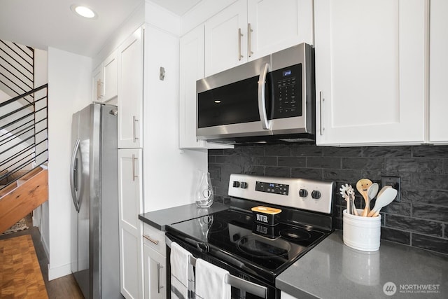 1055 S Cloverdale, Seattle, WA 98108 - kitchen with stainless steel appliances, white cabinets, backsplash, recessed lighting, and dark stone countertops