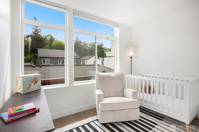 1055 S Cloverdale, Seattle, WA 98108 - bedroom with wood finished floors, a nursery area, and baseboards