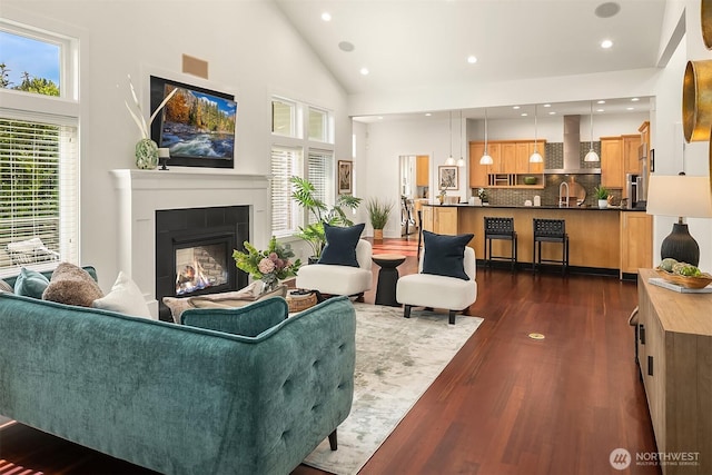 10022 NE 110th St, Kirkland, WA 98033 - living room with high vaulted ceiling, dark wood-style flooring, a glass covered fireplace, and recessed lighting
