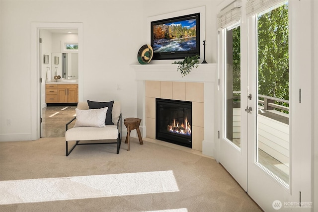 10022 NE 110th St, Kirkland, WA 98033 - living area featuring carpet flooring, a tiled fireplace, and baseboards