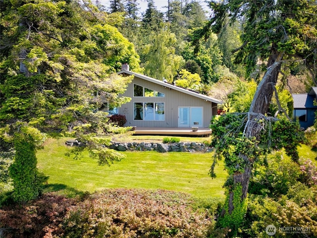 16004 Snee Oosh Rd, La Conner, WA 98257 - rear view of house featuring a deck, a lawn, and a chimney