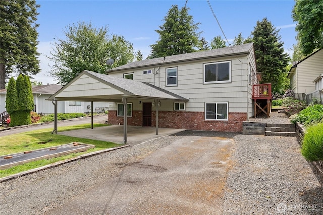 525527 16th Ave SE, Olympia, WA 98501 - view of front of property with brick siding, roof with shingles, and a detached carport