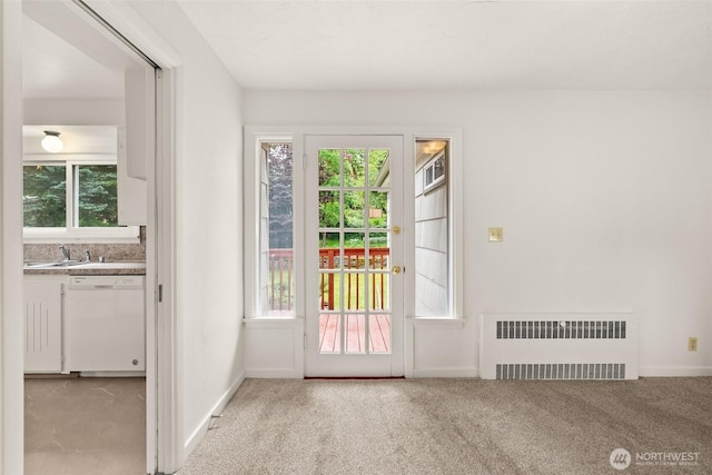 525527 16th Ave SE, Olympia, WA 98501 - doorway with radiator heating unit, light colored carpet, baseboards, and a sink