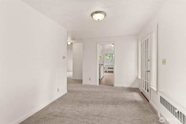525527 16th Ave SE, Olympia, WA 98501 - carpeted empty room with radiator heating unit and baseboards