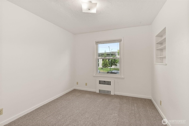525527 16th Ave SE, Olympia, WA 98501 - unfurnished room with radiator, carpet flooring, a textured ceiling, and baseboards