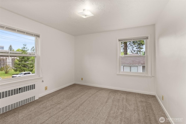 525527 16th Ave SE, Olympia, WA 98501 - carpeted empty room featuring radiator heating unit, plenty of natural light, and baseboards