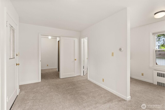 525527 16th Ave SE, Olympia, WA 98501 - unfurnished bedroom with radiator, carpet flooring, and baseboards