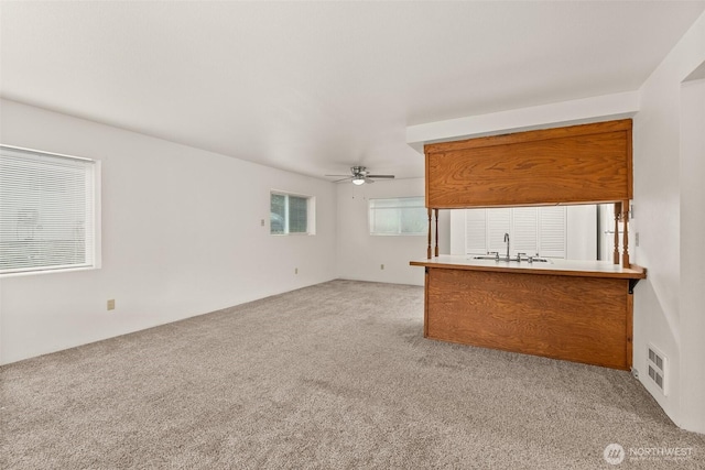 525527 16th Ave SE, Olympia, WA 98501 - unfurnished living room with light colored carpet, ceiling fan, and a sink