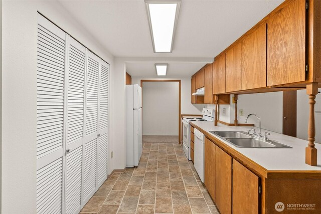 525527 16th Ave SE, Olympia, WA 98501 - kitchen featuring white appliances, a sink, light countertops, light stone finish flooring, and under cabinet range hood