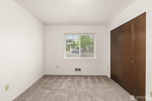 525527 16th Ave SE, Olympia, WA 98501 - unfurnished bedroom featuring carpet flooring, a textured ceiling, and a closet