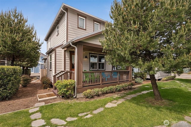 422 Vine Maple Ln SW, Ocean Shores, WA 98569 - view of front facade featuring a porch and a front lawn