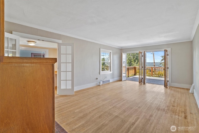 243 N Garden St, Bellingham, WA 98225 - unfurnished living room with ornamental molding, baseboards, and light wood finished floors