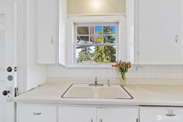 243 N Garden St, Bellingham, WA 98225 - kitchen featuring a sink, white cabinets, light countertops, and backsplash
