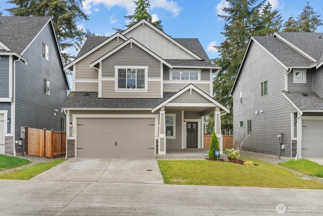 3808 181st St E, Tacoma, WA 98446 - craftsman-style home featuring an attached garage, concrete driveway, board and batten siding, a porch, and roof with shingles