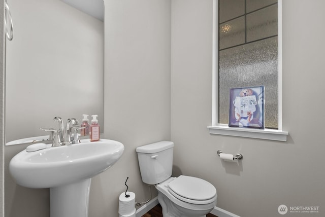 3808 181st St E, Tacoma, WA 98446 - bathroom featuring toilet, baseboards, and a sink