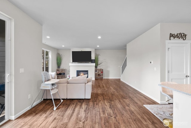 3808 181st St E, Tacoma, WA 98446 - living area featuring wood finished floors, a glass covered fireplace, recessed lighting, and baseboards