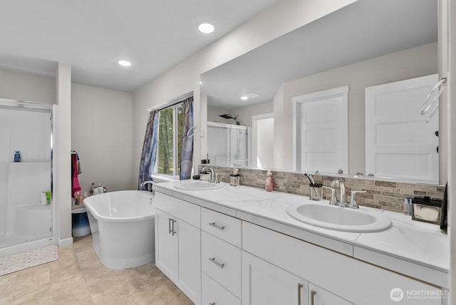 3808 181st St E, Tacoma, WA 98446 - bathroom with a stall shower, double vanity, a freestanding bath, decorative backsplash, and recessed lighting