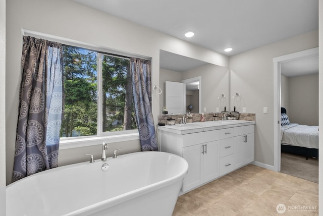 3808 181st St E, Tacoma, WA 98446 - full bath featuring double vanity, a soaking tub, ensuite bathroom, baseboards, and tile patterned flooring