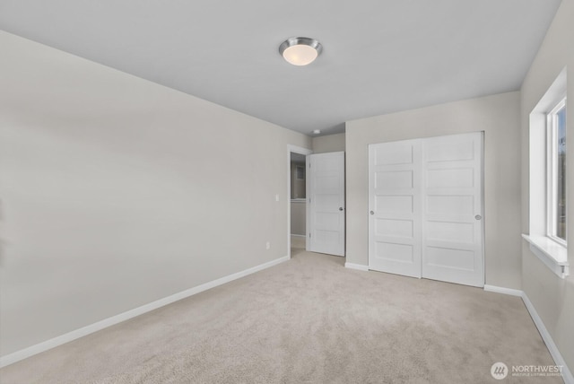 3808 181st St E, Tacoma, WA 98446 - unfurnished bedroom with carpet flooring, baseboards, a closet, and multiple windows