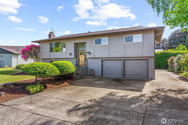 6015 NW Perthshire Rd, Vancouver, WA 98663 - split foyer home featuring a garage, a chimney, and concrete driveway