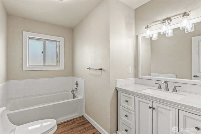 6015 NW Perthshire Rd, Vancouver, WA 98663 - full bathroom with a garden tub, vanity, toilet, wood finished floors, and baseboards