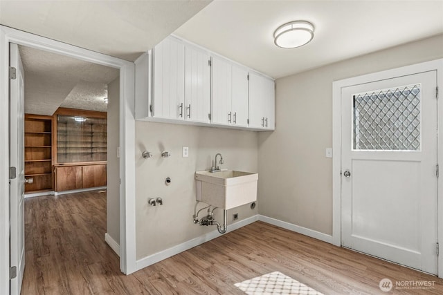 6015 NW Perthshire Rd, Vancouver, WA 98663 - laundry area featuring cabinet space, light wood-style flooring, baseboards, and hookup for a washing machine