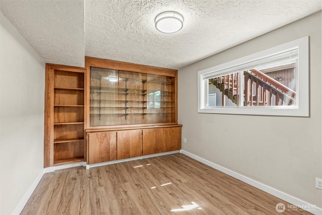 6015 NW Perthshire Rd, Vancouver, WA 98663 - unfurnished dining area with wood finished floors, a textured ceiling, and baseboards