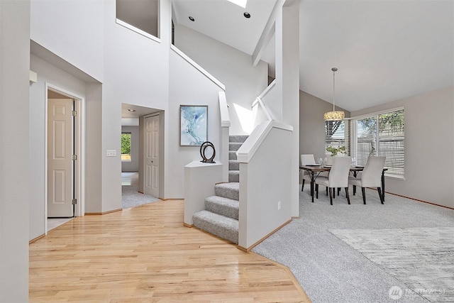 30515 127th Pl SE, Auburn, WA 98092 - entryway featuring plenty of natural light, stairs, high vaulted ceiling, wood finished floors, and baseboards