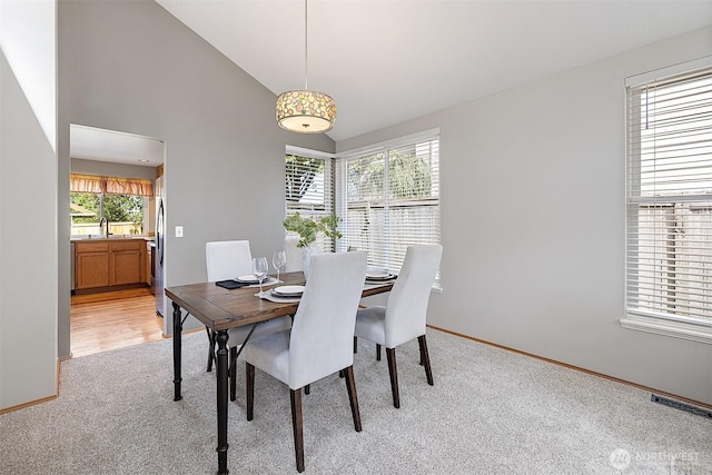 30515 127th Pl SE, Auburn, WA 98092 - dining space with light colored carpet, baseboards, and high vaulted ceiling