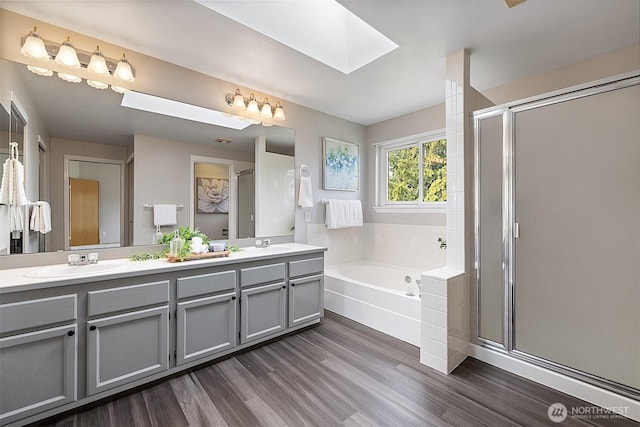 30515 127th Pl SE, Auburn, WA 98092 - full bathroom with a skylight, a bath, double vanity, wood finished floors, and a shower stall